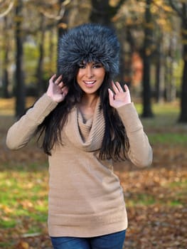 Beautiful woman spending time in park during autumn season