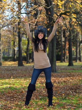 Beautiful woman spending time in park during autumn season