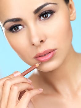 Portrait of beautiful woman she is doing makeup