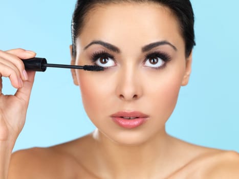 Portrait of beautiful woman she is doing makeup