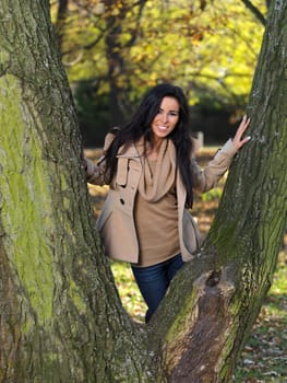 Beautiful woman spending time in park during autumn season