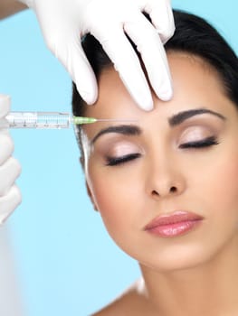 Beautiful woman gets botox injection in her face