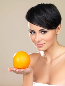 Portrait of beautiful woman, she holding fresh orange