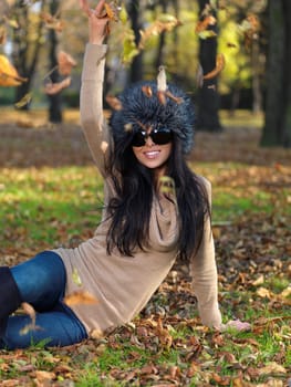 Beautiful woman spending time in park during autumn season