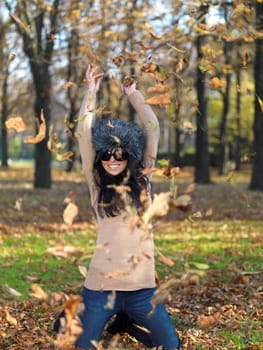 Beautiful woman spending time in park during autumn season