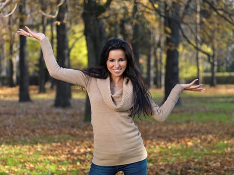 Beautiful woman spending time in park during autumn season