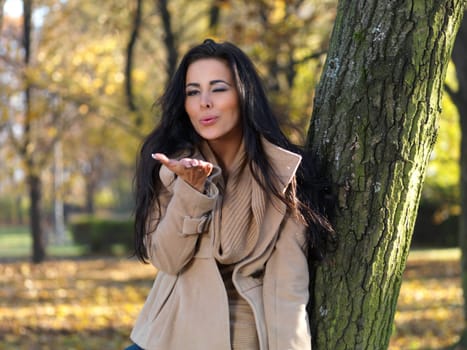 Beautiful woman spending time in park during autumn season