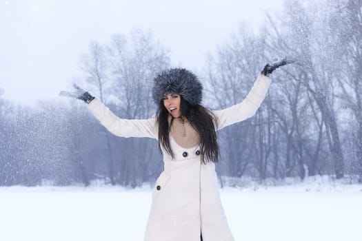 Beautiful and sexy woman in snowy winter outdoors