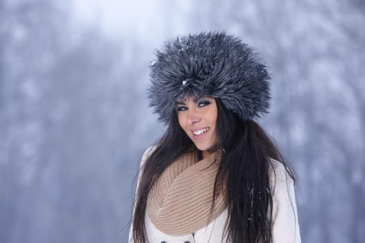 Beautiful and sexy woman in snowy winter outdoors
