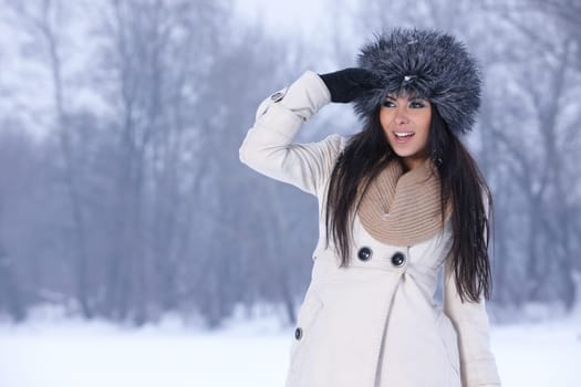 Beautiful and sexy woman in snowy winter outdoors