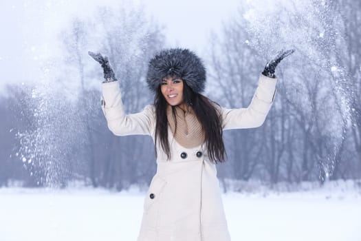 Beautiful and sexy woman in snowy winter outdoors