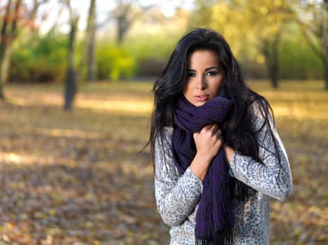 Beautiful woman spending time in park during autumn season