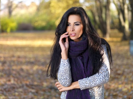 Beautiful woman spending time in park during autumn season