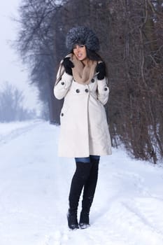 Beautiful and sexy woman in snowy winter outdoors