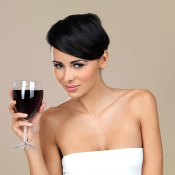 Portrait of beautiful woman, she holding glass of red wine