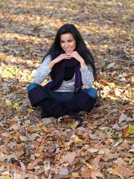 Beautiful woman spending time in park during autumn season