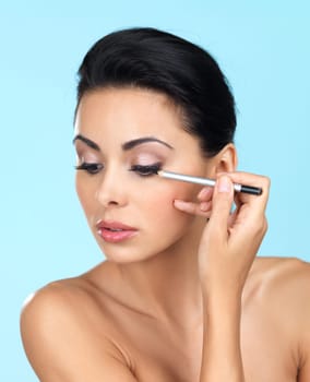 Portrait of beautiful woman she is doing makeup