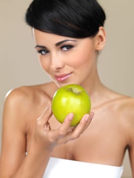 Portrait of beautiful woman, she holding green apple