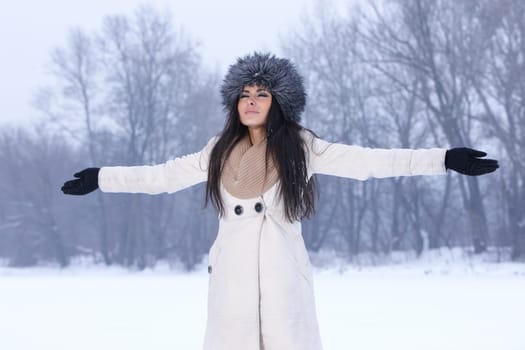 Beautiful and sexy woman in snowy winter outdoors