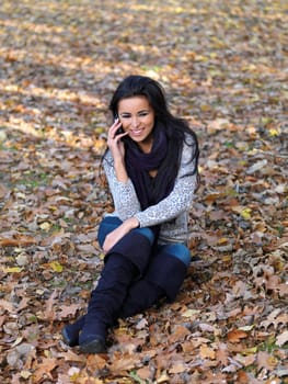 Beautiful woman spending time in park during autumn season