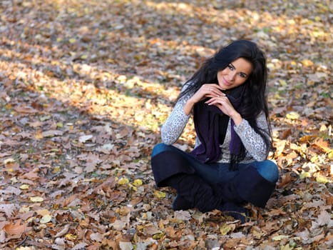 Beautiful woman spending time in park during autumn season