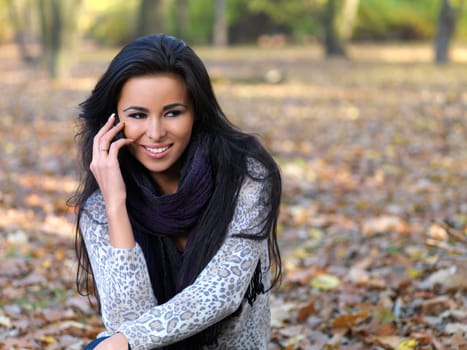 Beautiful woman spending time in park during autumn season