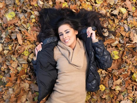 Beautiful woman spending time in park during autumn season