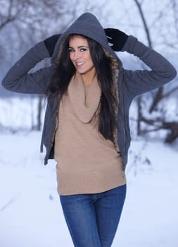 Beautiful and sexy woman in snowy winter outdoors