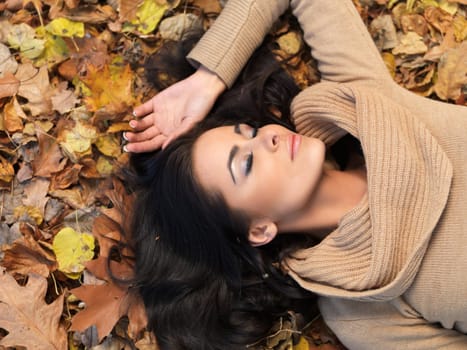 Beautiful woman spending time in park during autumn season