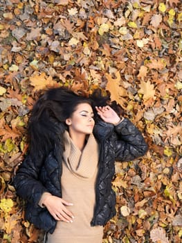 Beautiful woman spending time in park during autumn season