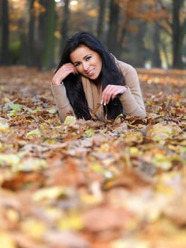 Beautiful woman spending time in park during autumn season