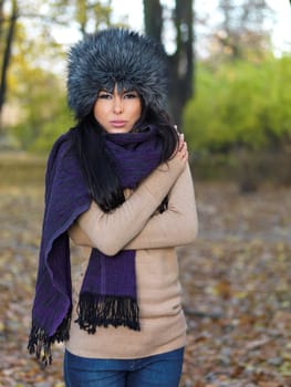 Beautiful woman spending time in park during autumn season