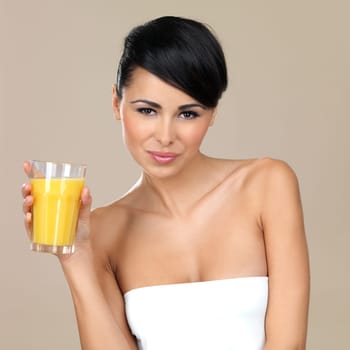 Portrait of beautiful woman, she holding glass of orange juice