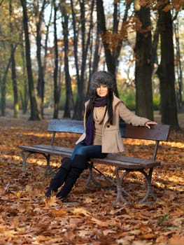 Beautiful woman spending time in park during autumn season