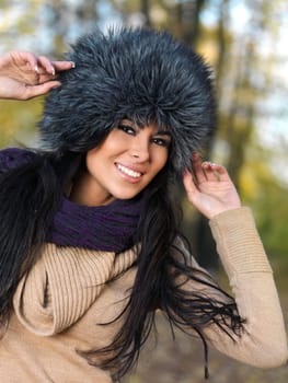 Beautiful woman spending time in park during autumn season