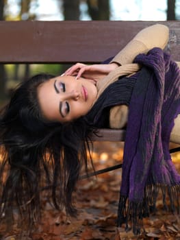 Beautiful woman spending time in park during autumn season