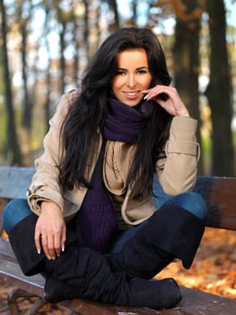 Beautiful woman spending time in park during autumn season