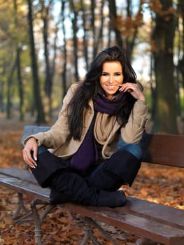 Beautiful woman spending time in park during autumn season