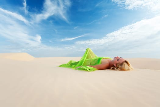 Beautiful woman sleeping in the middle of desert