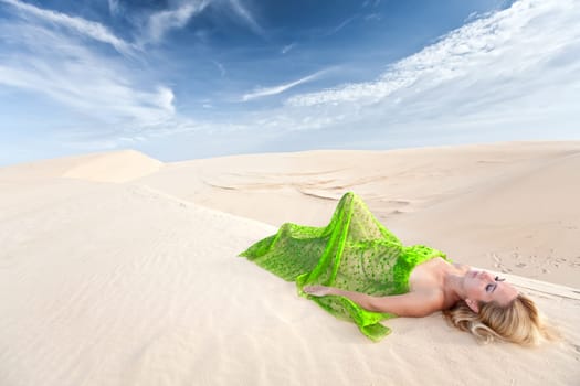 Beautiful woman sleeping in the middle of desert