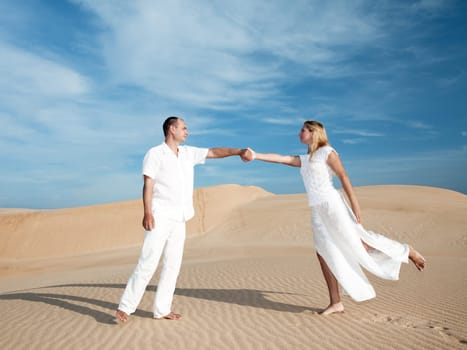 Meeting of men and woman at desert dunes