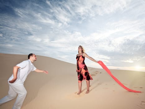 Man is running to loving girl in desert