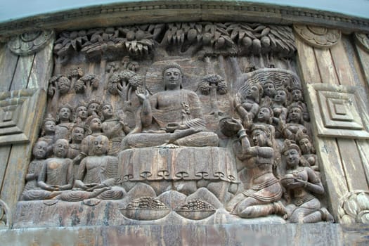 Bas relief sculpture of Buddha in sermon at stupa in Darjeeling, India, Asia