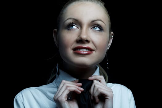 Beautiful business woman wearing black tie and white shirt isolated on black background