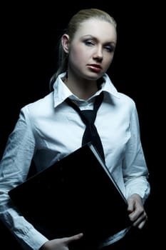 Beautiful business woman wearing black tie and white shirt holding folder isolated on black background