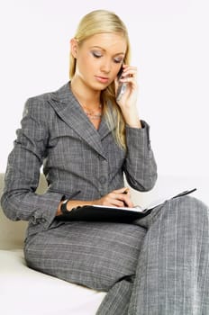 Young business woman talking by phone
