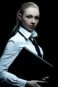 Beautiful business woman wearing black tie and white shirt holding folder isolated on black background