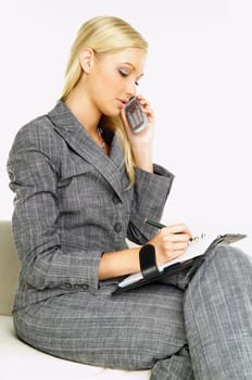 Young business woman talking by phone