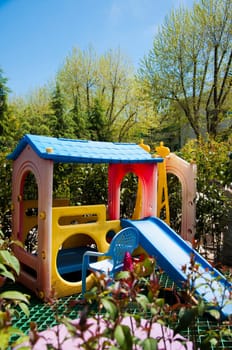 an elevated view of slides and swings in the park