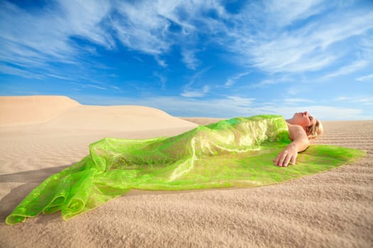 Beautiful woman sleeping in the middle of desert